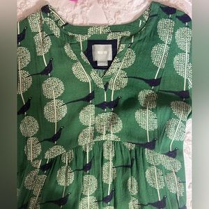 Green Maeve tunic with bird pattern from Anthropologie.